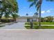 Well-manicured front yard with lush green grass and mature trees, leading to a welcoming home exterior at 9109 134Th Way, Seminole, FL 33776