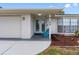Charming front entrance with double doors, a cozy bench, and well-maintained landscaping at 9109 134Th Way, Seminole, FL 33776