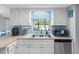 Kitchen area featuring a microwave, stainless steel appliances, and a window view at 9109 134Th Way, Seminole, FL 33776