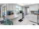 Bright kitchen features white cabinets, a blue backsplash, stainless appliances, and a breakfast bar at 9109 134Th Way, Seminole, FL 33776
