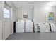 Laundry room featuring a washer, dryer, and folding tables at 9109 134Th Way, Seminole, FL 33776