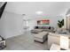 Open concept living room featuring tile floors, neutral colored furniture, and access to the dining area at 9109 134Th Way, Seminole, FL 33776