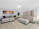 Large living room with neutral-colored couches, tile flooring and a decorative plant at 9109 134Th Way, Seminole, FL 33776