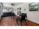 Screened-in patio with brick flooring, hot tub, and outdoor furniture at 9109 134Th Way, Seminole, FL 33776
