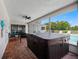 Screened-in patio with hot tub, overlooking fenced yard and pool at 9109 134Th Way, Seminole, FL 33776
