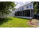 A view of the screened-in patio and backyard of this lovely home at 932 Woodbridge Ct, Safety Harbor, FL 34695