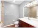 Bathroom featuring a single sink vanity, wood look tiled floors, and shower at 932 Woodbridge Ct, Safety Harbor, FL 34695