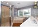 Bathroom featuring a glass shower enclosure, soaking tub, double sink vanity, and recessed lighting at 932 Woodbridge Ct, Safety Harbor, FL 34695