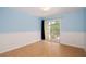 Cozy bedroom with light blue walls, wainscoting, tile flooring, and sliding glass door to patio at 932 Woodbridge Ct, Safety Harbor, FL 34695