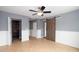 Spacious bedroom featuring tile flooring, modern ceiling fan, and sliding barn door to bathroom at 932 Woodbridge Ct, Safety Harbor, FL 34695