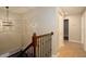 Upstairs hallway featuring neutral tones and decorative light fixture at 932 Woodbridge Ct, Safety Harbor, FL 34695