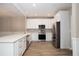 Modern kitchen with white cabinets, stainless steel appliances, and a sleek design, offering a contemporary cooking space at 932 Woodbridge Ct, Safety Harbor, FL 34695
