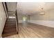 Spacious living room with light plank flooring, sliding glass doors and modern light fixture at 932 Woodbridge Ct, Safety Harbor, FL 34695