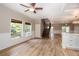 Bright living room boasting hardwood floors, large windows, and an open layout, perfect for entertaining and relaxing at 932 Woodbridge Ct, Safety Harbor, FL 34695