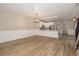 Open concept living space with white kitchen, light plank flooring, and modern lighting at 932 Woodbridge Ct, Safety Harbor, FL 34695