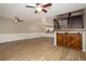 Open floor plan featuring living room, staircase with wood accent barn door, and plank flooring at 932 Woodbridge Ct, Safety Harbor, FL 34695