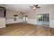 Bright living room with updated flooring, ceiling fans, and access to outdoor patio at 932 Woodbridge Ct, Safety Harbor, FL 34695
