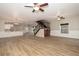 Open floor plan featuring living room, kitchen, staircase, and light plank flooring at 932 Woodbridge Ct, Safety Harbor, FL 34695