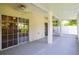 Enclosed patio features concrete flooring, and large sliding glass doors leading into the residence at 932 Woodbridge Ct, Safety Harbor, FL 34695