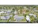 Aerial view displays a community with boat docks, boat houses, swimming pools, and charming waterfront homes at 105 E North Branch Rd, Ruskin, FL 33570