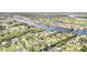Expansive aerial view showcases the desirable neighborhood, tranquil waterways, and lush greenery at 105 E North Branch Rd, Ruskin, FL 33570