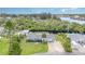 Aerial view of the home featuring a waterway, lush trees, vibrant lawn and a large driveway at 105 E North Branch Rd, Ruskin, FL 33570