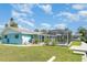 Lush backyard featuring a screened pool, mature trees, and a picturesque waterway at 105 E North Branch Rd, Ruskin, FL 33570