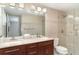 Updated bathroom with double sinks, stylish vanity, and glass enclosed shower with tile surround at 105 E North Branch Rd, Ruskin, FL 33570