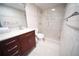 Tiled bathroom with glass shower, and dark wood vanity with marble countertop at 105 E North Branch Rd, Ruskin, FL 33570