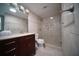 Updated bathroom featuring a glass shower, tile surround and a wood vanity at 105 E North Branch Rd, Ruskin, FL 33570