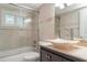 The bathroom has a shower and tub combination with a glass shower door and unique stone vessel sink at 105 E North Branch Rd, Ruskin, FL 33570