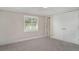 This cozy bedroom features a light gray carpet, a bright window, and a closet at 105 E North Branch Rd, Ruskin, FL 33570