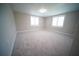 A naturally lit bedroom with neutral carpet and paint at 105 E North Branch Rd, Ruskin, FL 33570