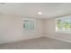 Cozy bedroom with plush carpeting, neutral paint, and bright windows with charming shutter accents at 105 E North Branch Rd, Ruskin, FL 33570