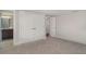 Comfortable bedroom with carpeted floors, neutral walls, and a view into an attached bathroom and closet at 105 E North Branch Rd, Ruskin, FL 33570