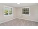 This bedroom features neutral walls, new gray carpet, and a window with stylish white shutters at 105 E North Branch Rd, Ruskin, FL 33570