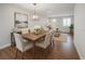Dining room with wood floors, table with seating for six, and view into the living room at 105 E North Branch Rd, Ruskin, FL 33570