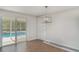 Bright dining area with hard floors, sliding glass doors to pool, and modern lighting; ideal for entertaining at 105 E North Branch Rd, Ruskin, FL 33570