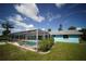 Exterior view of home with a screened pool, patio, and lush yard at 105 E North Branch Rd, Ruskin, FL 33570