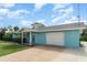 Side view of a light blue single-Gathering home featuring an attached garage and manicured landscaping at 105 E North Branch Rd, Ruskin, FL 33570