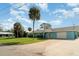 Inviting light blue single-story home with a spacious driveway and lush front lawn, a true gem at 105 E North Branch Rd, Ruskin, FL 33570