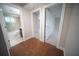Hallway view showcasing the bathroom with tub and the bedroom with carpet at 105 E North Branch Rd, Ruskin, FL 33570