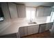 Modern kitchen with white countertops, gray cabinets, and stainless steel appliances at 105 E North Branch Rd, Ruskin, FL 33570