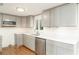 Renovated kitchen featuring stainless steel appliances, gray cabinets, and quartz countertops at 105 E North Branch Rd, Ruskin, FL 33570