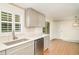 Renovated kitchen featuring stainless steel appliances, gray cabinets, and quartz countertops at 105 E North Branch Rd, Ruskin, FL 33570