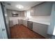 Open kitchen featuring gray cabinets, stainless steel appliances, and hardwood floors at 105 E North Branch Rd, Ruskin, FL 33570