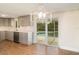 Modern kitchen with quartz countertops, gray cabinetry, and stainless appliances, with view to pool at 105 E North Branch Rd, Ruskin, FL 33570