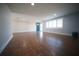 Spacious living room featuring wood-look tile flooring, neutral paint, and a front door at 105 E North Branch Rd, Ruskin, FL 33570