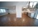 Open-concept living room and kitchen featuring wood floors, recessed lights and gray cabinets at 105 E North Branch Rd, Ruskin, FL 33570