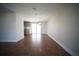 Bright, open-concept living room with wood floors, light fixtures, and sliding door access to the backyard at 105 E North Branch Rd, Ruskin, FL 33570